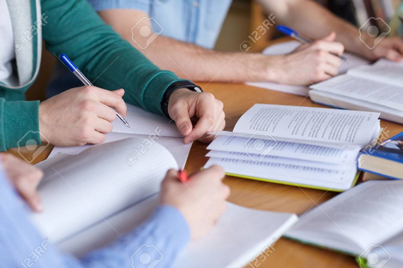 people, learning, education and school concept - close up of students hands with books or textbooks writing to notebooks - 53713431 people, learning, education and school concept - close up of students hands with books or textbooks writing to notebooks - 53713431