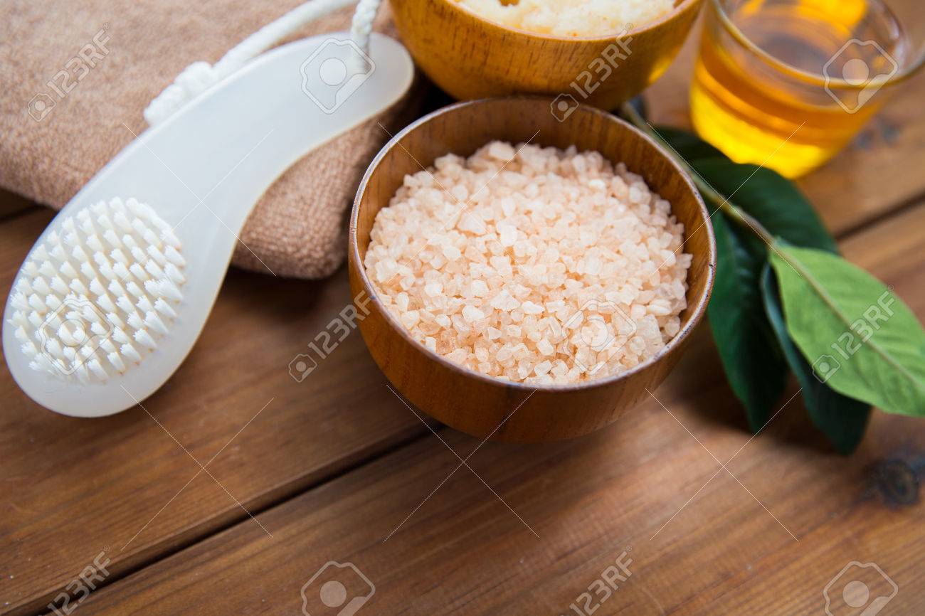 beauty, spa, body care, natural cosmetics and bath concept - close up of himalayan pink salt with brush on wooden table - 54056835 beauty, spa, body care, natural cosmetics and bath concept - close up of himalayan pink salt with brush on wooden table - 54056835