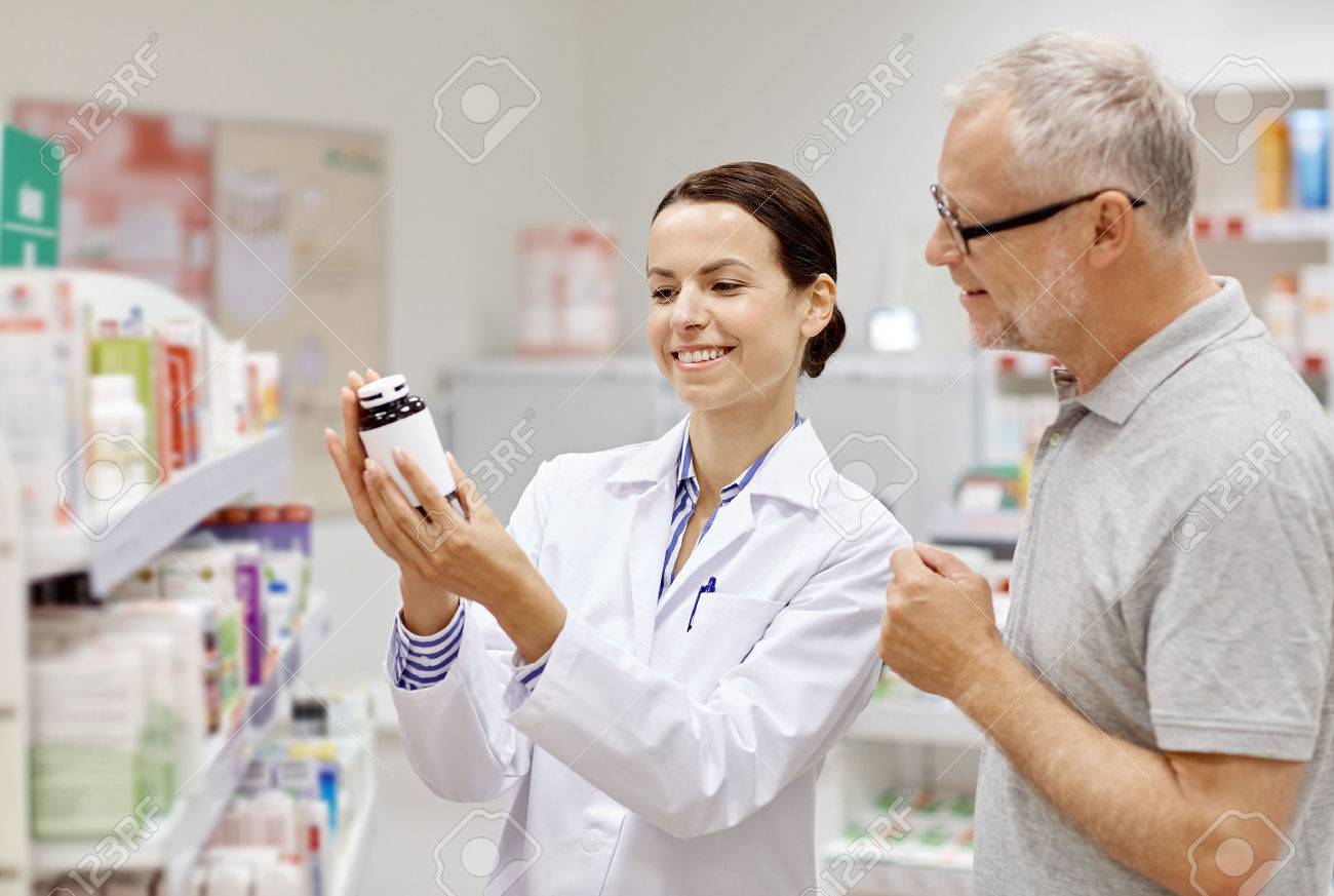 medicine, pharmaceutics, health care and people concept - happy pharmacist showing drug to senior man customer at drugstore - 54776679 medicine, pharmaceutics, health care and people concept - happy pharmacist showing drug to senior man customer at drugstore - 54776679