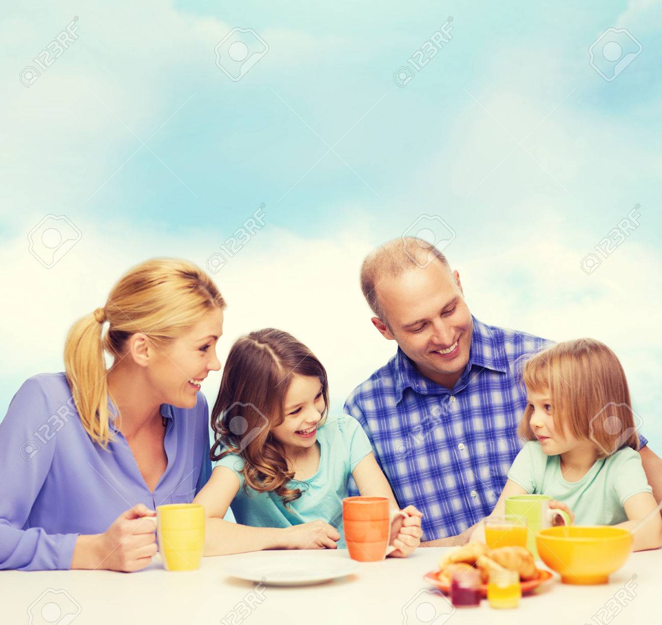 food, family, children, hapiness and people concept - happy family with two kids having breakfast at home - 57276045 food, family, children, hapiness and people concept - happy family with two kids having breakfast at home - 57276045