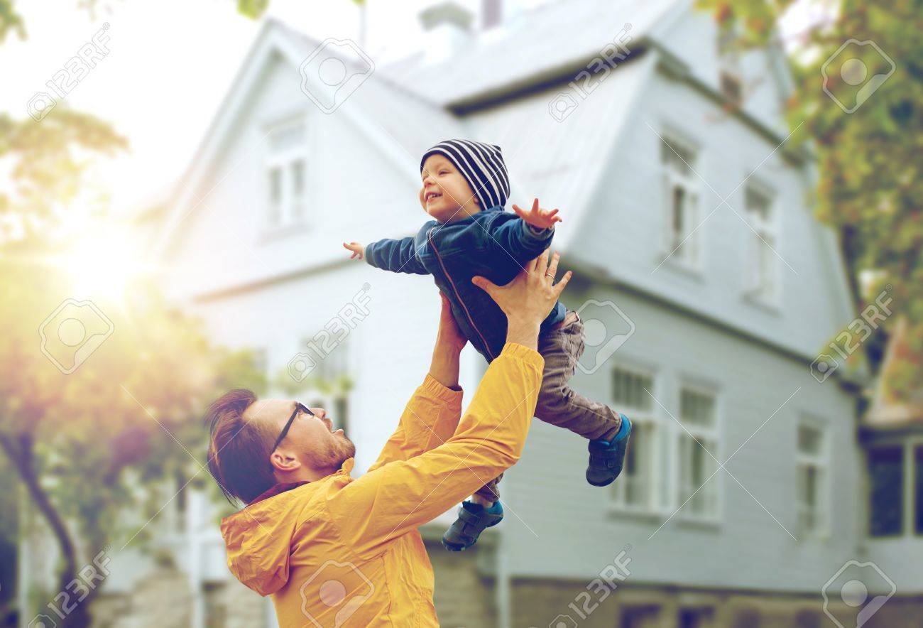 family, childhood, fatherhood, leisure and people concept - happy father and little son playing and having fun outdoors over living house background - 63161309 family, childhood, fatherhood, leisure and people concept - happy father and little son playing and having fun outdoors over living house background - 63161309