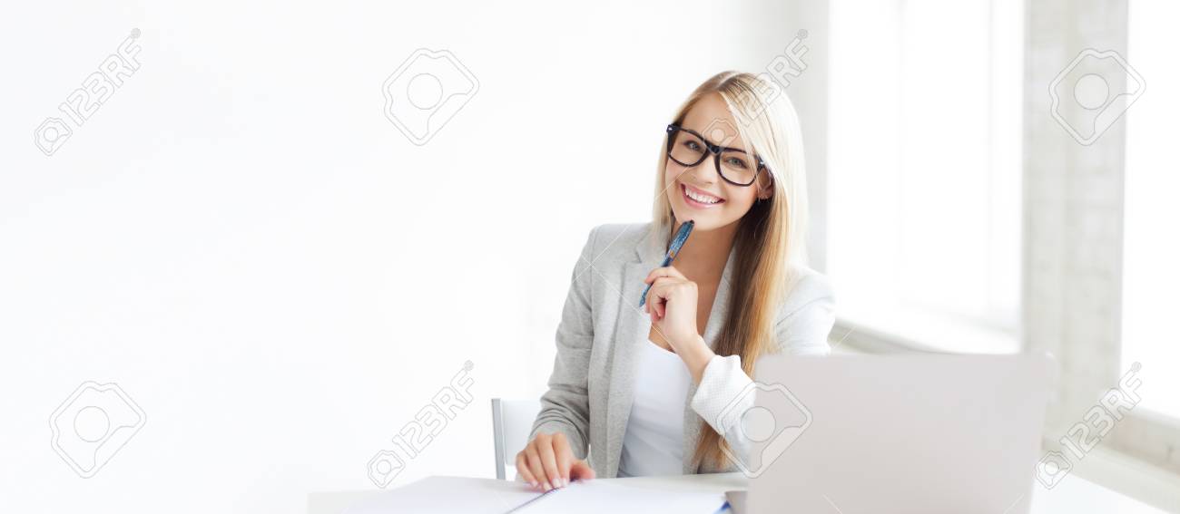 indoor picture of smiling woman with documents and pen - 63415356 indoor picture of smiling woman with documents and pen - 63415356