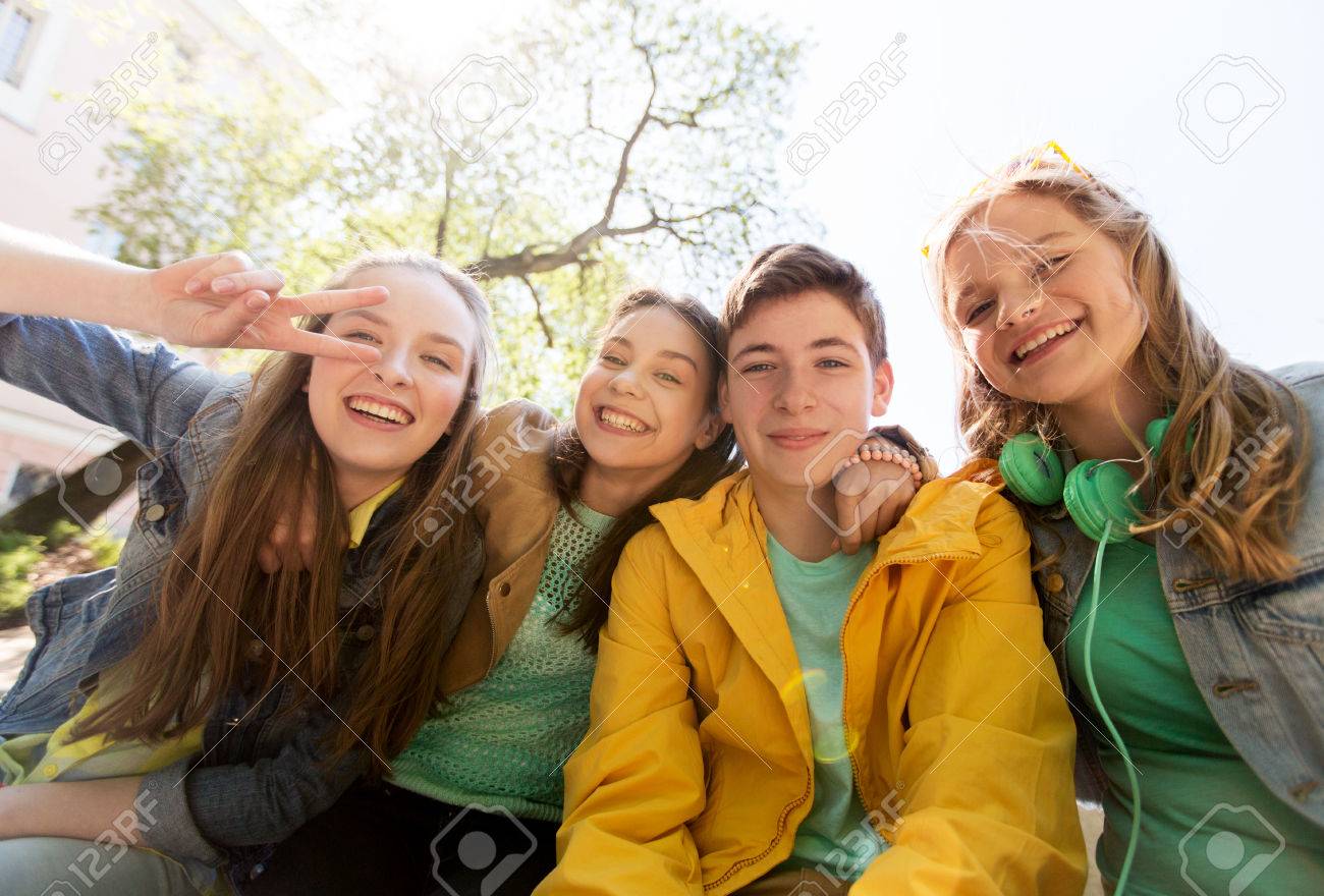 friendship and people concept - happy teenage friends or high school students having fun and making faces - 64298094 friendship and people concept - happy teenage friends or high school students having fun and making faces - 64298094