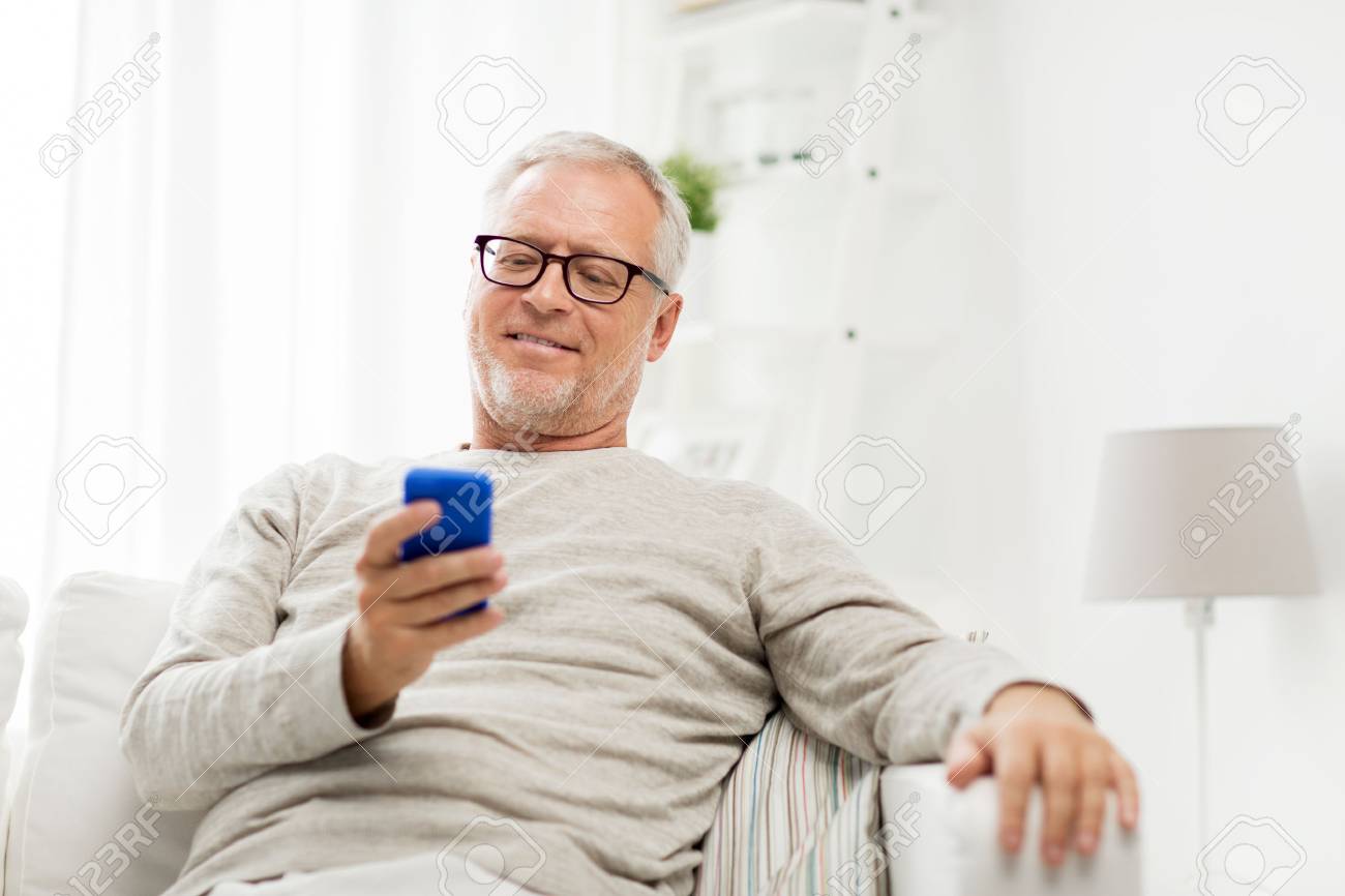 Technology, People, Lifestyle And Communication Concept - Happy Senior Man Dialing  Phone Number And Texting On Smartphone At Home Stock Photo, Picture and  Royalty Free Image. Image 64677597.