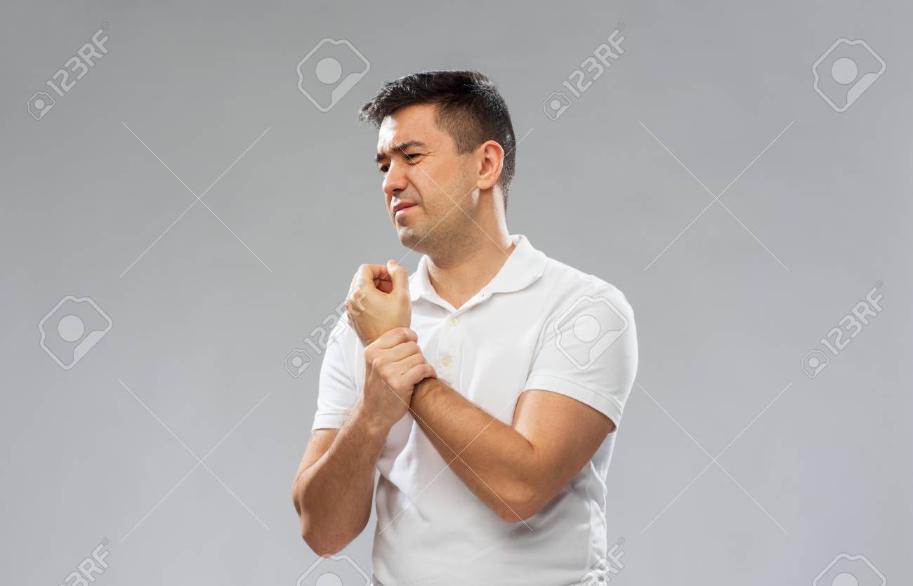 Unhappy Man Suffering From Pain In Hand Stock Photo Picture And