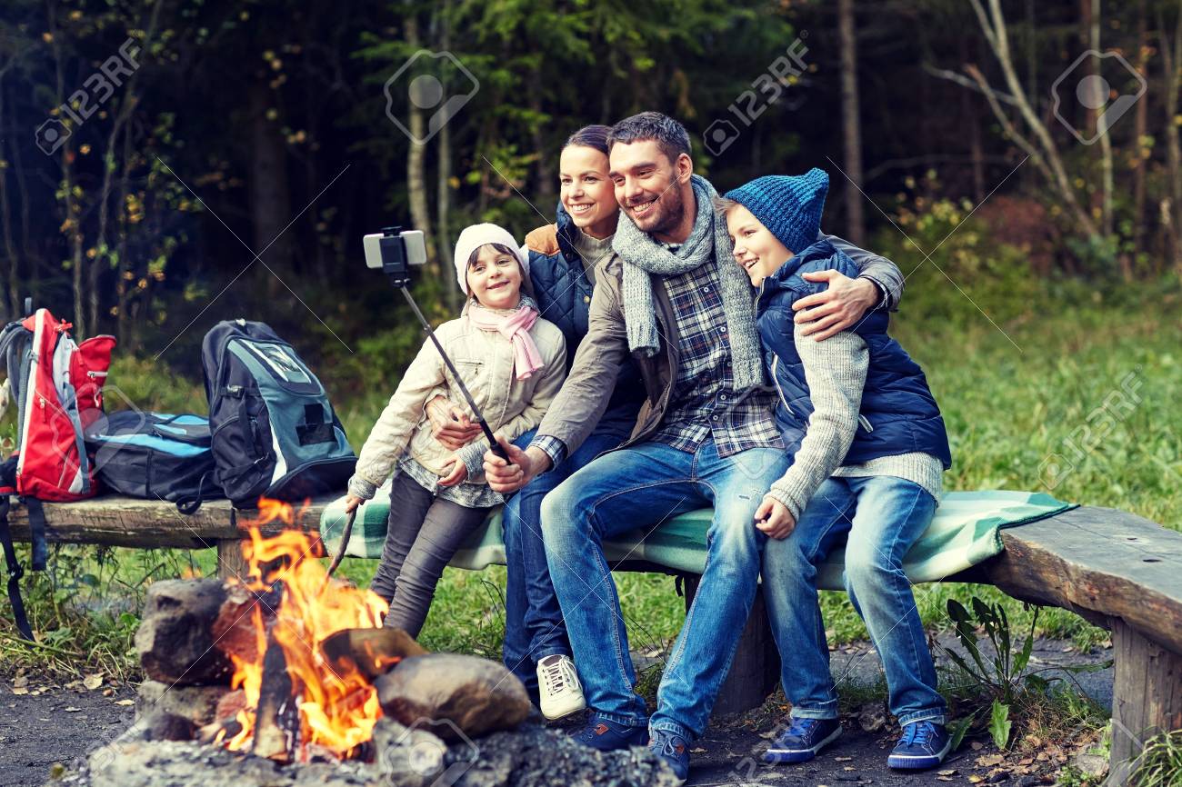 family camping in the woods camping travel tourism hike and people concept happy family sitting on bench camping travel tourism hike and people concept happy family family camping in the woods camping travel tourism hike and people concept happy family sitting on bench camping travel tourism hike and people concept happy family