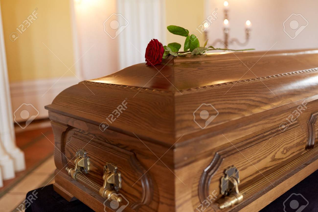 funeral and mourning concept - red rose flower on wooden coffin in church - 88451169 funeral and mourning concept - red rose flower on wooden coffin in church - 88451169