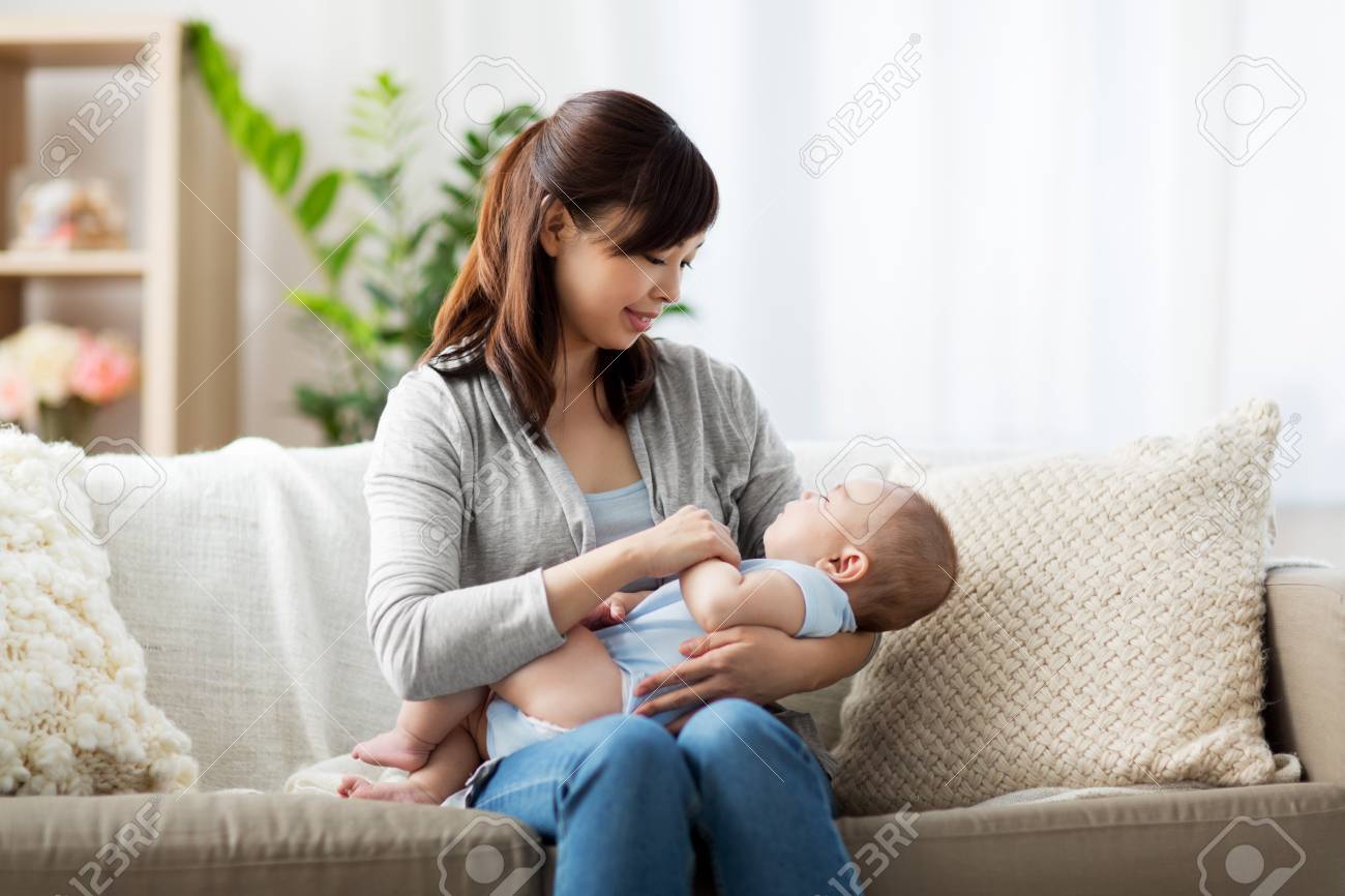 happy asian mother holding sleeping baby boy - 103423505 happy asian mother holding sleeping baby boy - 103423505