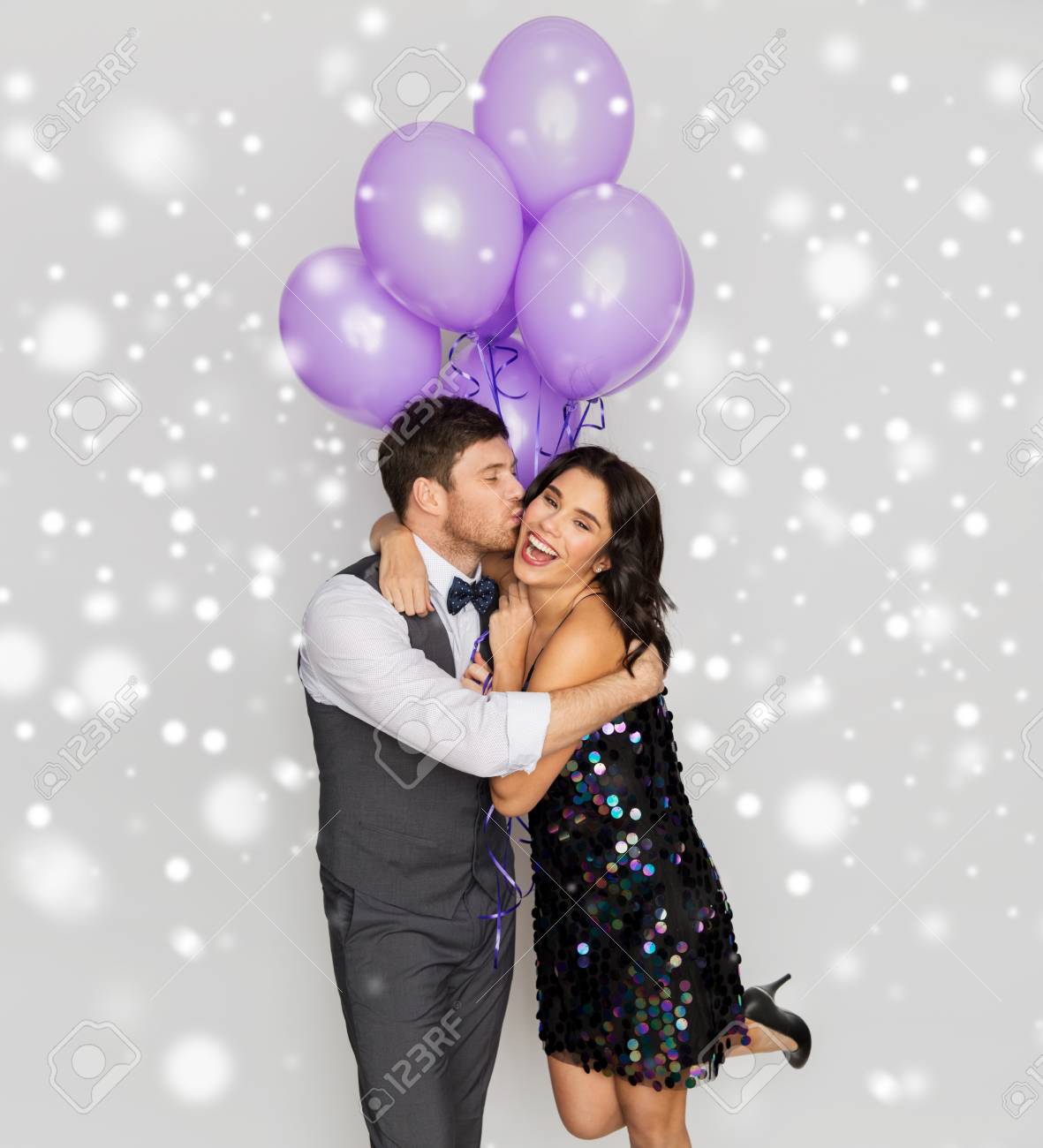 happy couple with violet balloons kissing at party - 110623124 happy couple with violet balloons kissing at party - 110623124