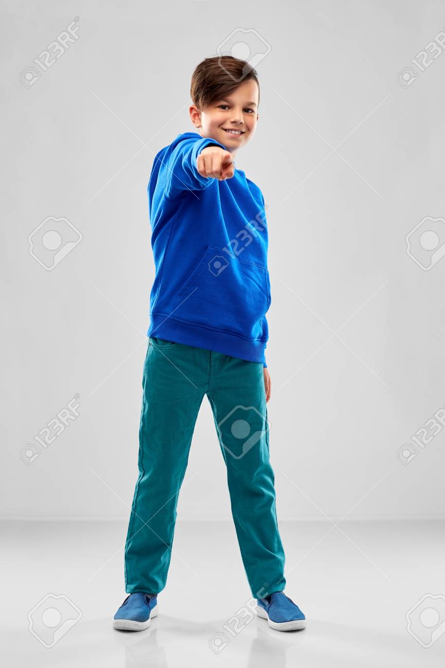 smiling boy in blue hoodier pointing finger - 121618012 smiling boy in blue hoodier pointing finger - 121618012