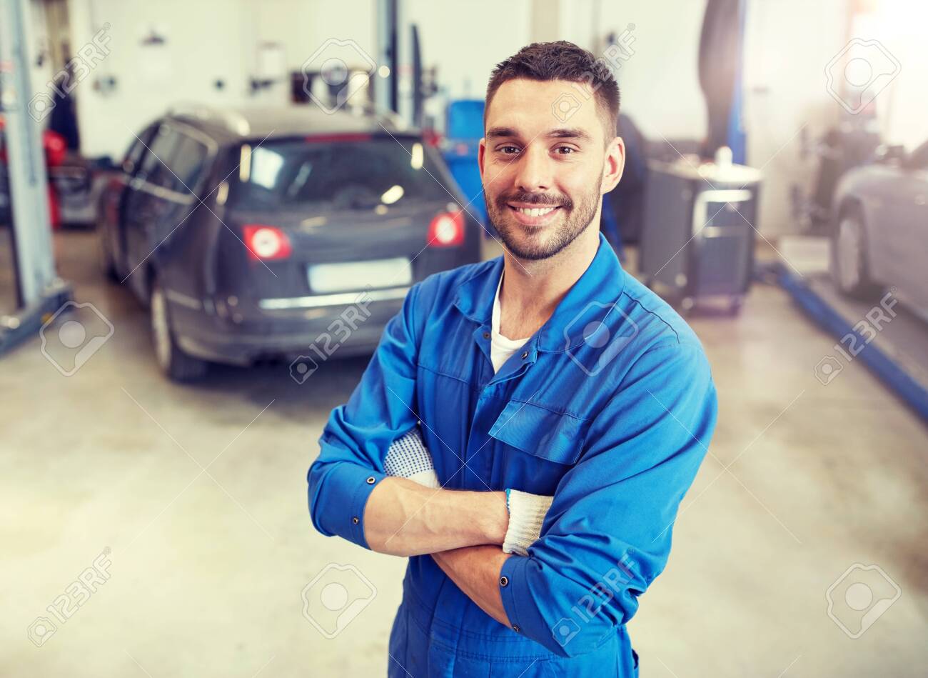 Happy auto mechanic man or smith at car workshop - 121996397 Happy auto mechanic man or smith at car workshop - 121996397