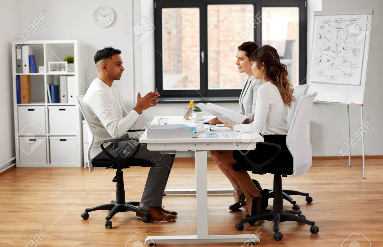 Recruiters having job interview with male employee - 121996703 Recruiters having job interview with male employee - 121996703