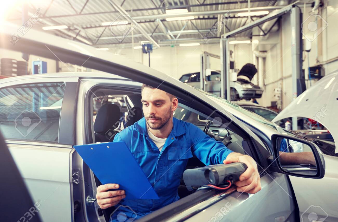 service, repair, maintenance and people concept - mechanic man with automotive diagnostic scanner and clipboard checking car system at workshop - 122209277 service, repair, maintenance and people concept - mechanic man with automotive diagnostic scanner and clipboard checking car system at workshop - 122209277