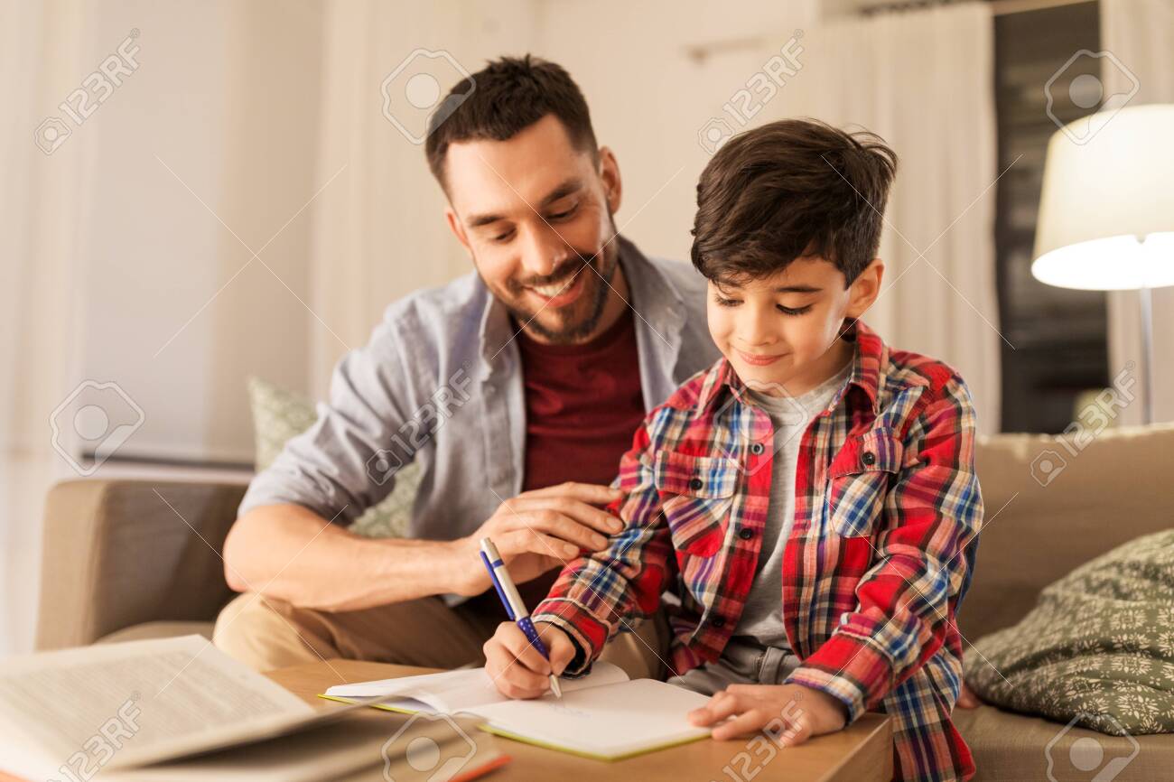 Father and son doing homework together - 122648495 Father and son doing homework together - 122648495