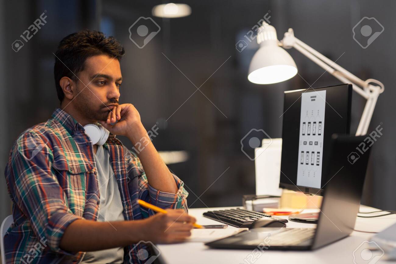 creative man with laptop working at night office - 123580626 creative man with laptop working at night office - 123580626