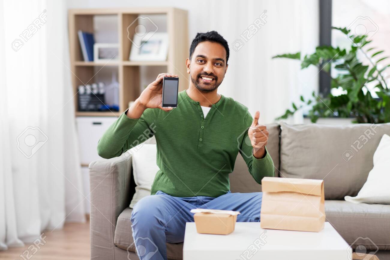 indian man using smartphone for food delivery - 123908455 indian man using smartphone for food delivery - 123908455
