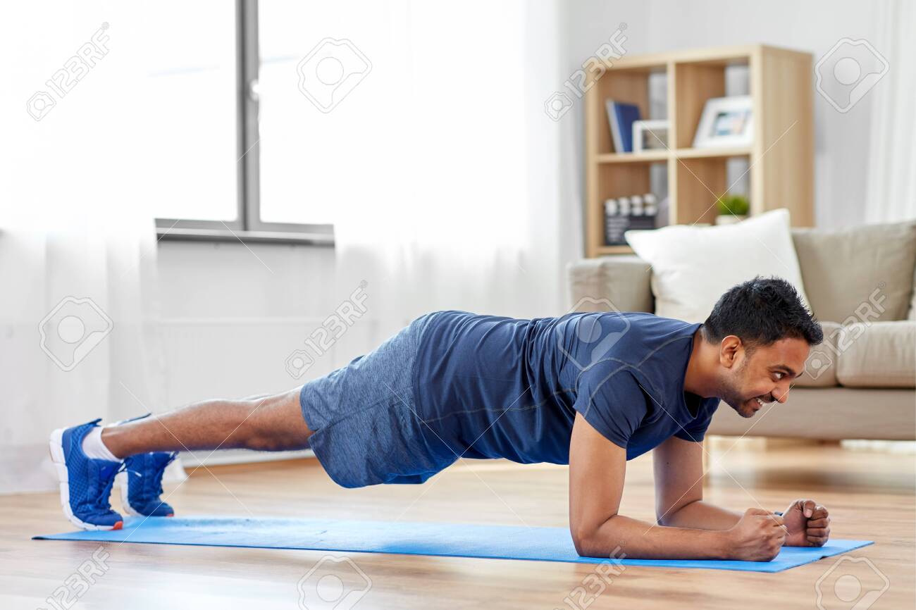 man doing plank exercise at home - 124311484 man doing plank exercise at home - 124311484