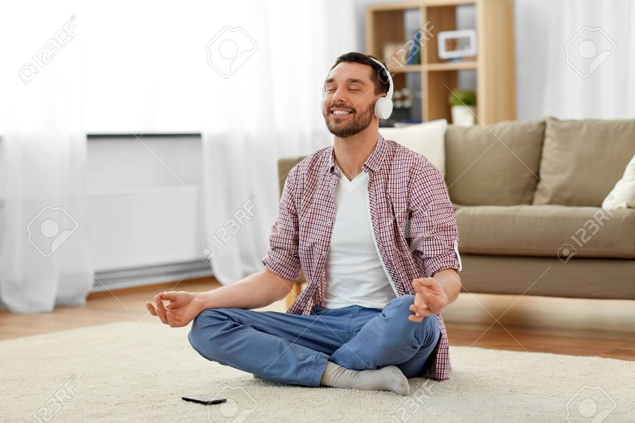 man in headphones meditating listening to music - 124455350 man in headphones meditating listening to music - 124455350