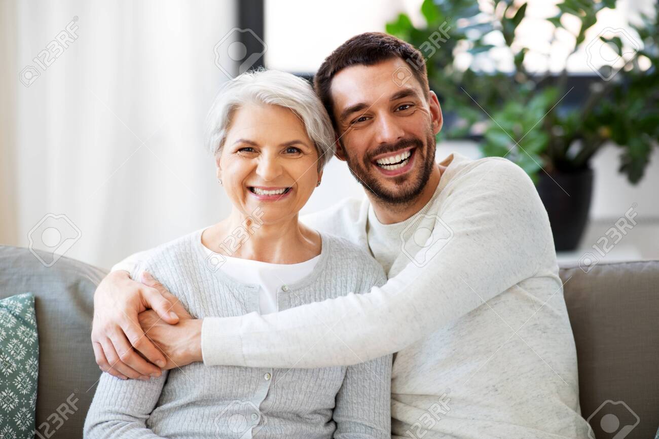 Senior Mother With Adult Son Hugging At Home Stock Photo, Picture and  Royalty Free Image. Image 125091533.