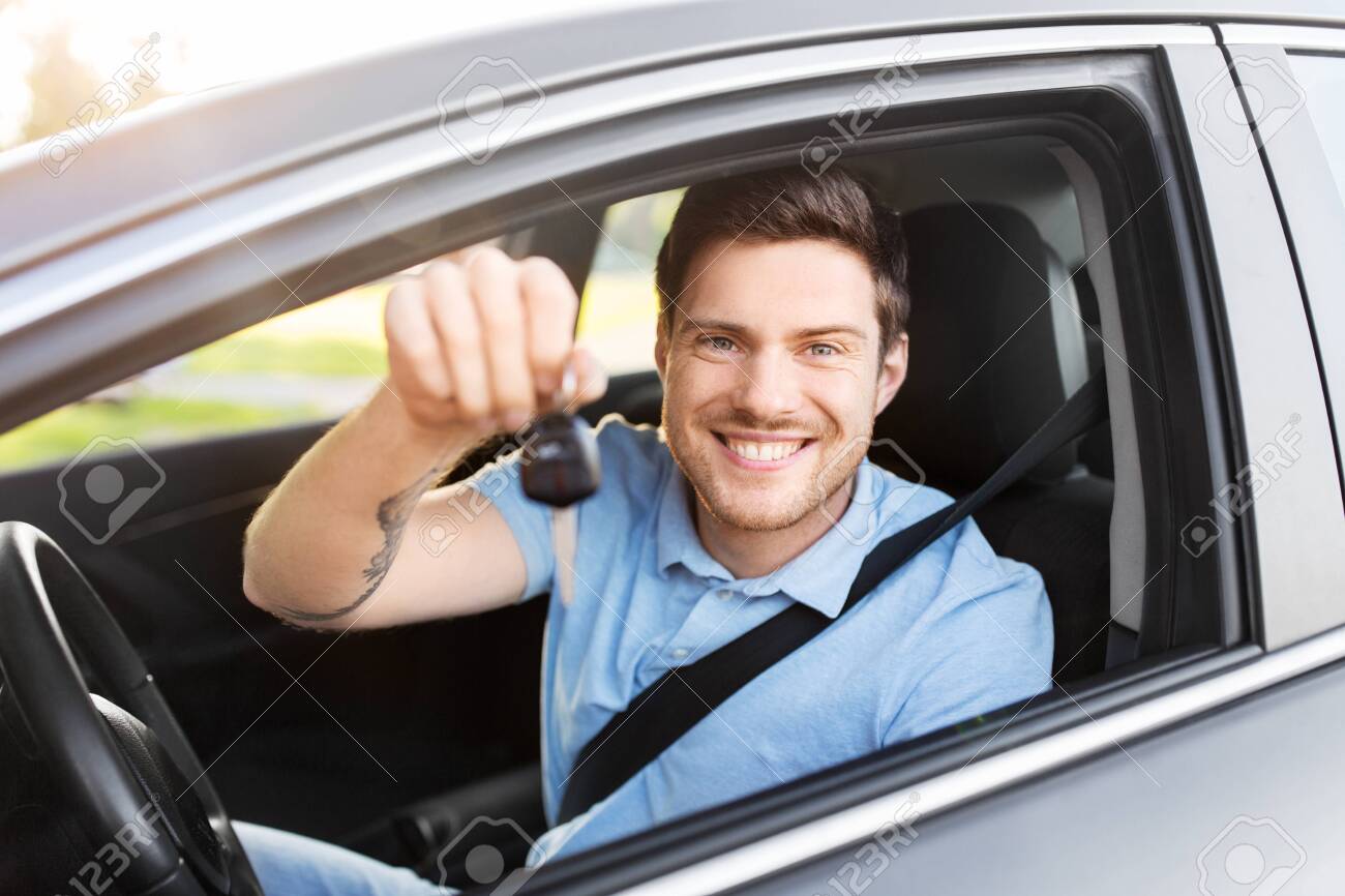 transport, vehicle and ownership concept - happy smiling man or driver with key sitting in car - 130120397 transport, vehicle and ownership concept - happy smiling man or driver with key sitting in car - 130120397