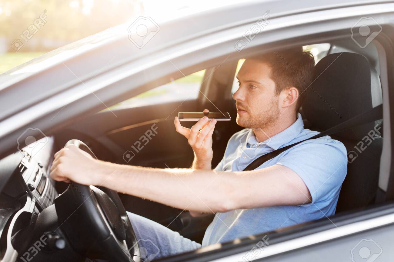 man driving car and recording voice by smartphone - 130587225 man driving car and recording voice by smartphone - 130587225