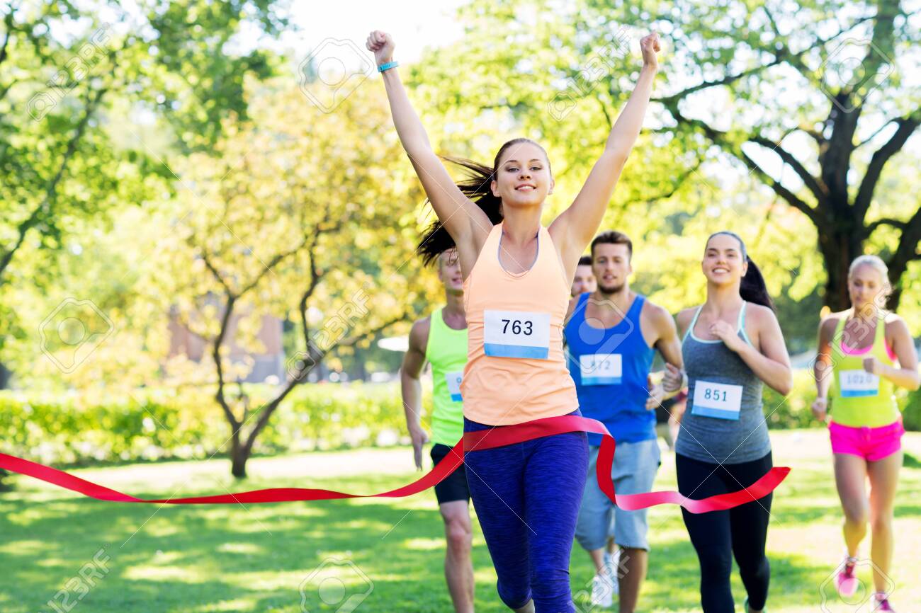 happy young female runner on finish winning race - 130918642 happy young female runner on finish winning race - 130918642