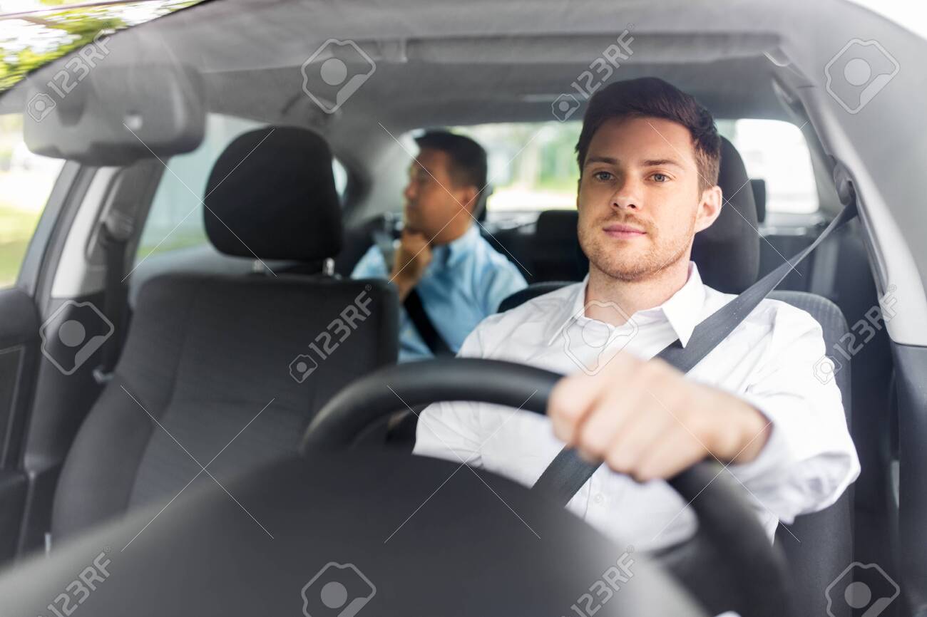 Male Driver Driving Car With Passenger Stock Photo, Picture And Royalty  Free Image. Image 131546049.