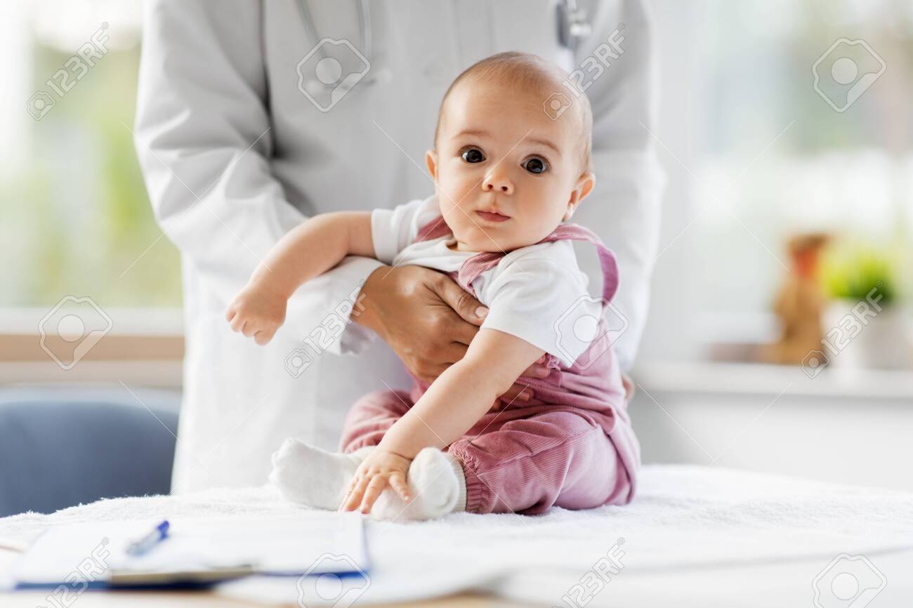 Female pediatrician doctor with baby at clinic - 133342119 Female pediatrician doctor with baby at clinic - 133342119