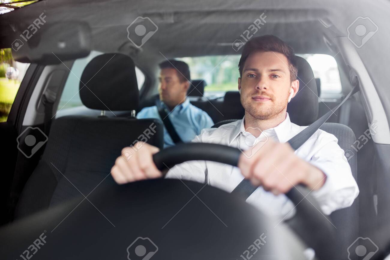 male driver with wireless earphones driving car - 134439802 male driver with wireless earphones driving car - 134439802
