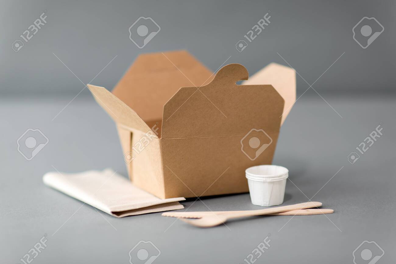 package, recycling and eating concept - disposable box for takeaway food with wooden fork, knife and napkin on table - 134961677 package, recycling and eating concept - disposable box for takeaway food with wooden fork, knife and napkin on table - 134961677