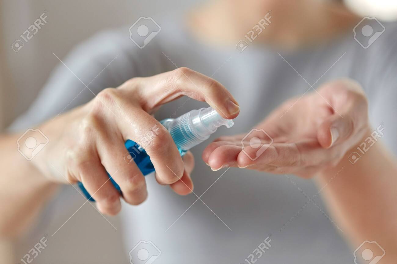close up of woman spraying hand sanitizer - 143609392 close up of woman spraying hand sanitizer - 143609392