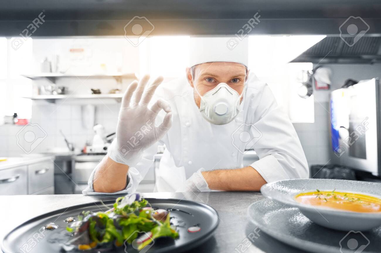 male chef in mask with food at restaurant kitchen - 144229510 male chef in mask with food at restaurant kitchen - 144229510