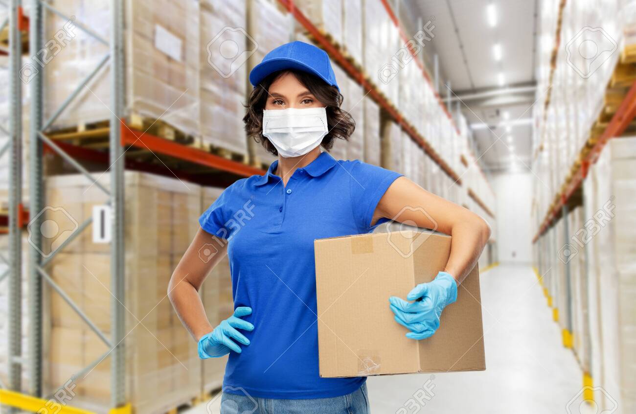 delivery woman in face mask holding parcel box - 145417324 delivery woman in face mask holding parcel box - 145417324