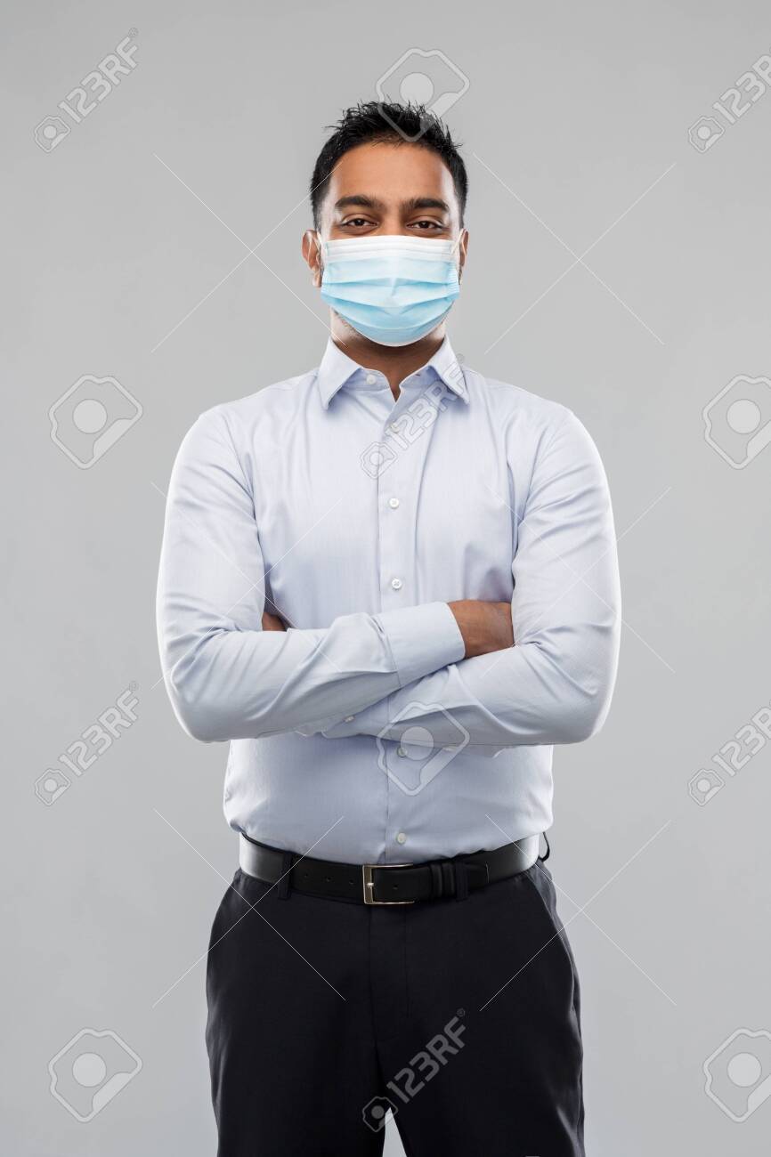 indian businessman in mask over grey background - 146902616 indian businessman in mask over grey background - 146902616