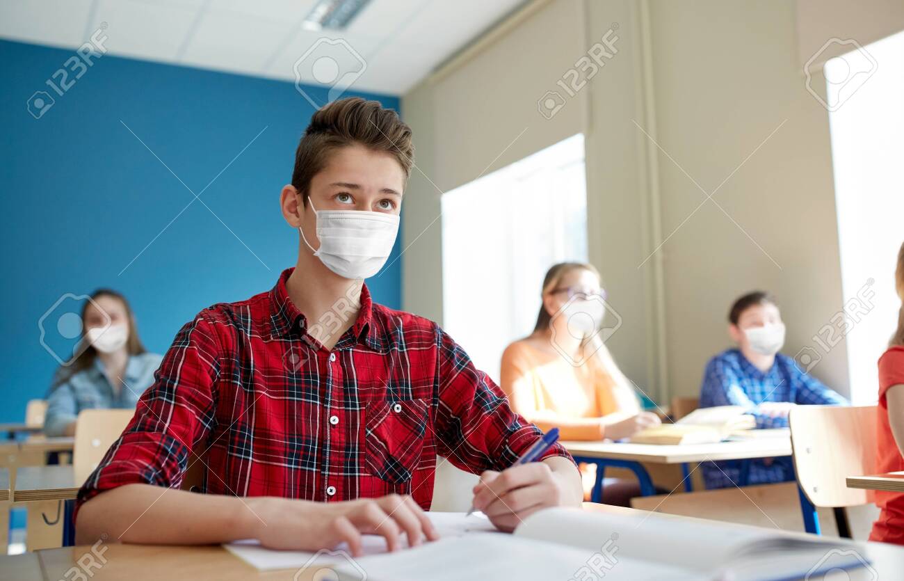 group of students in masks at school lesson - 147446136 group of students in masks at school lesson - 147446136