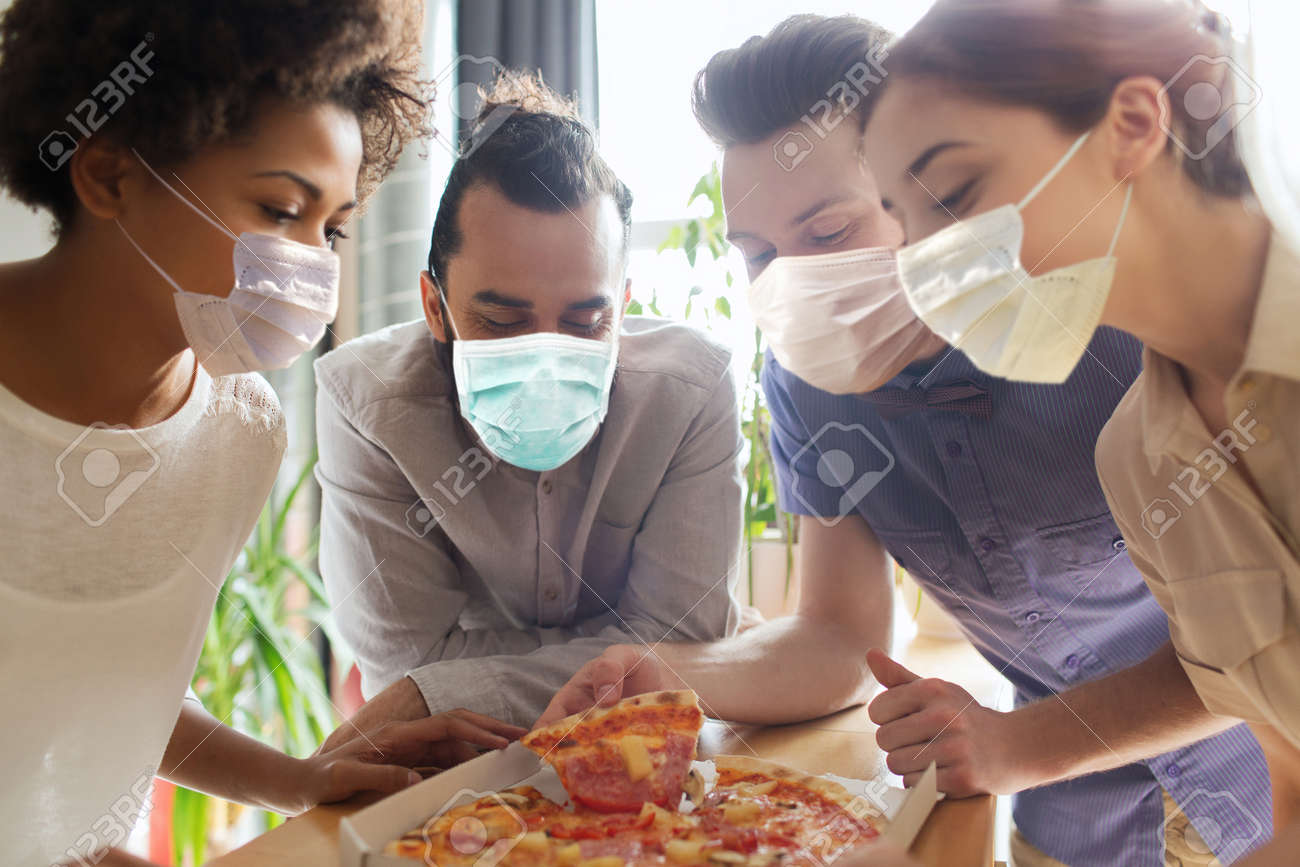 business team eating in masks pizza at office - 156545359 business team eating in masks pizza at office - 156545359
