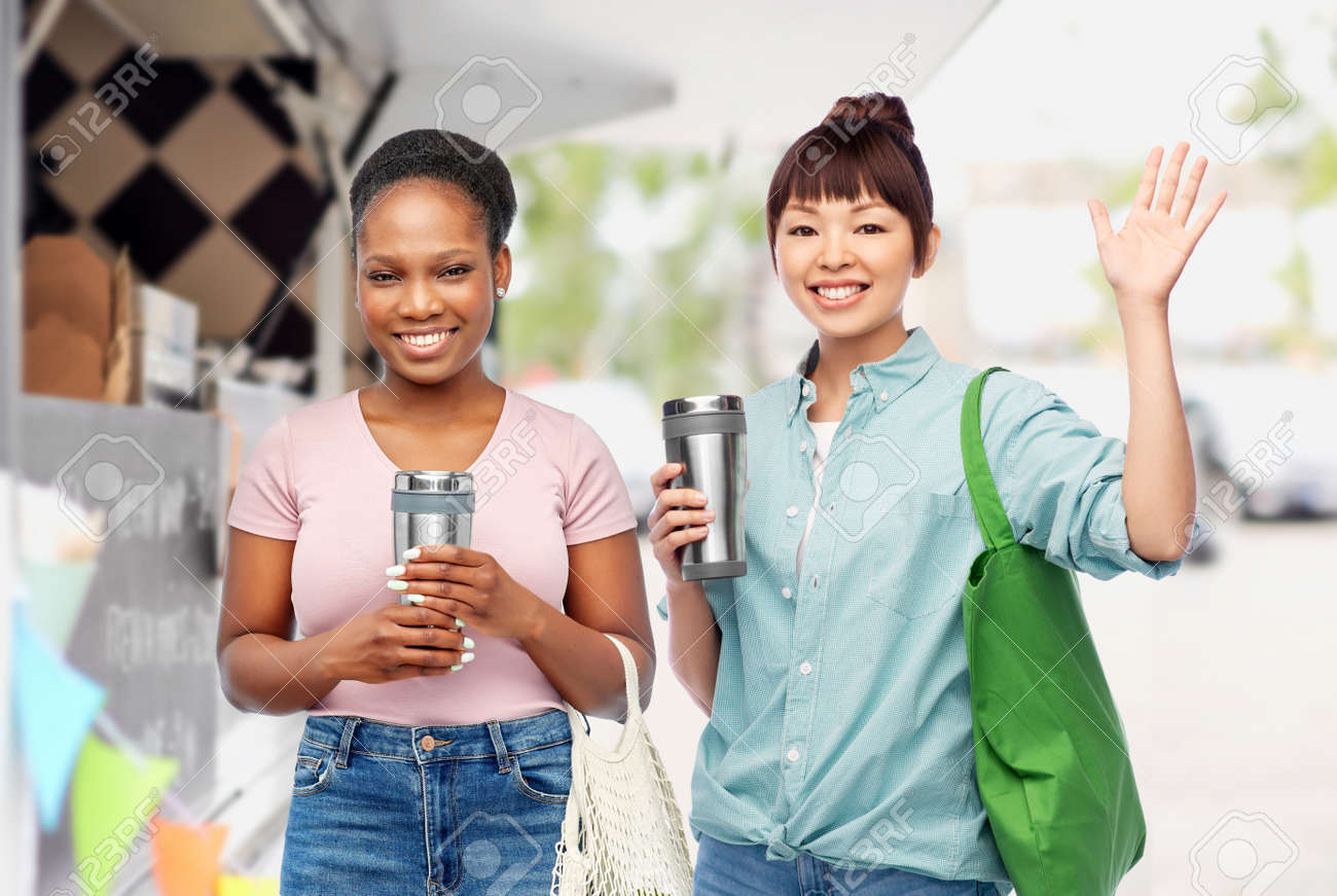 women with tumblers and bags over food truck - 169910281 women with tumblers and bags over food truck - 169910281