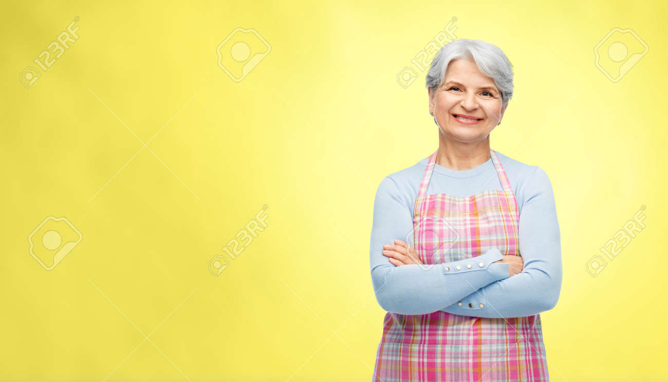 portrait of smiling senior woman in apron - 169910294 portrait of smiling senior woman in apron - 169910294