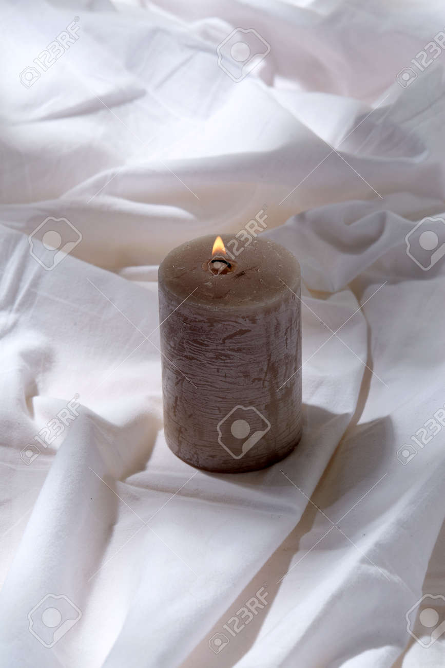 burning aroma candle on white sheet - 169966691 burning aroma candle on white sheet - 169966691