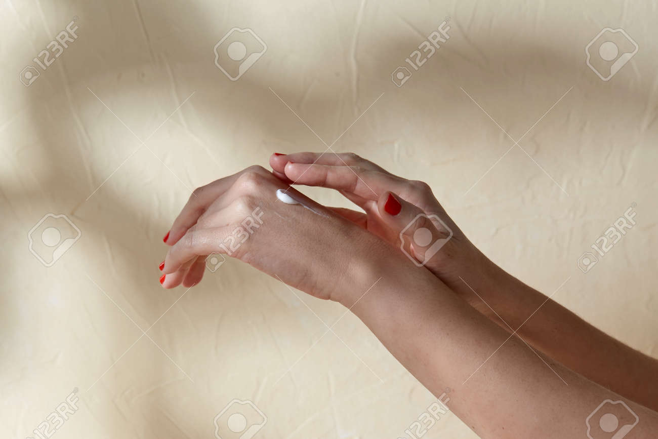 female hands applying moisturizer to skin - 169967132 female hands applying moisturizer to skin - 169967132