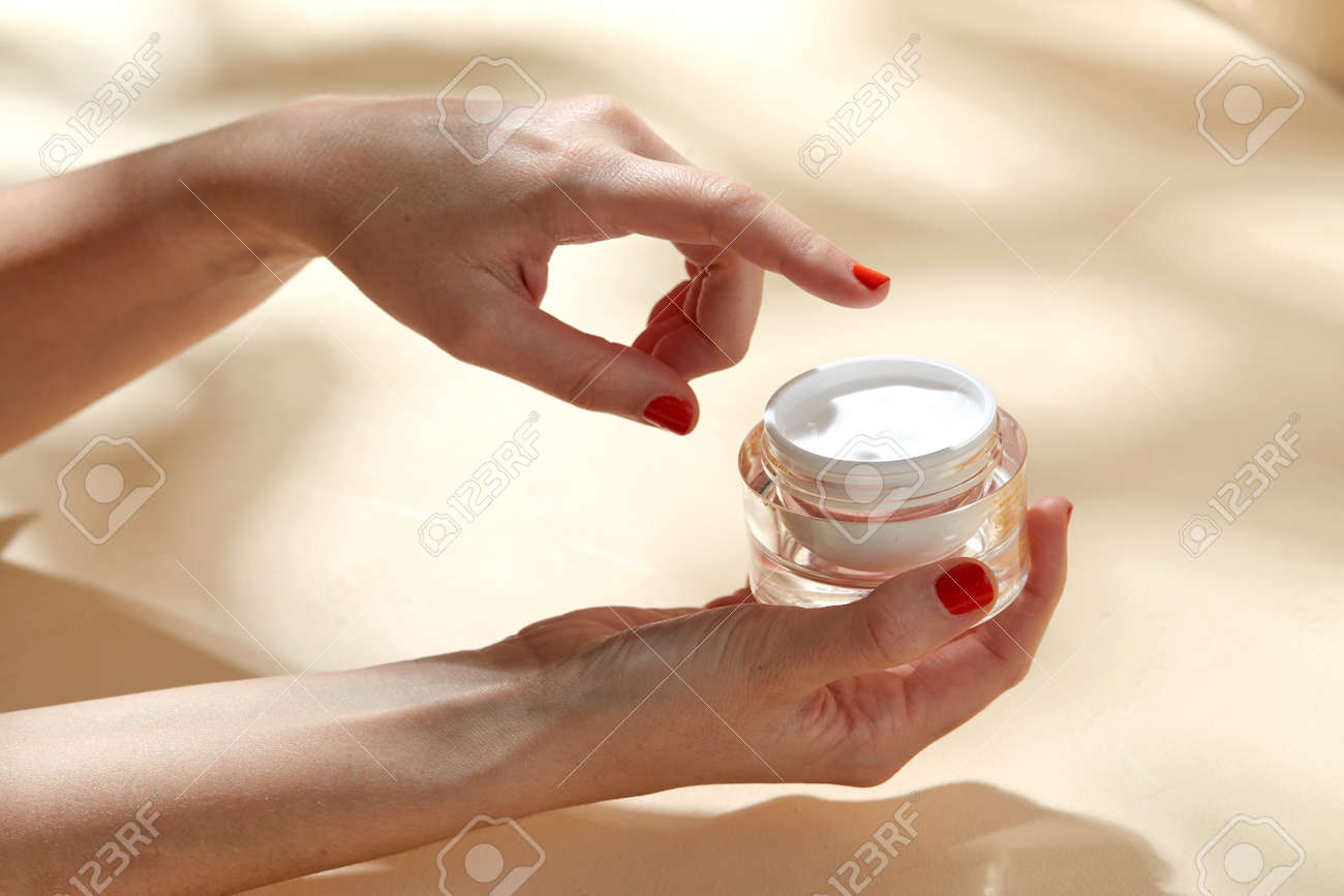 female hand holding jar of moisturizer - 169966569 female hand holding jar of moisturizer - 169966569