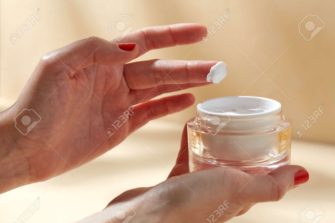 female hand holding jar of moisturizer - 169966625 female hand holding jar of moisturizer - 169966625