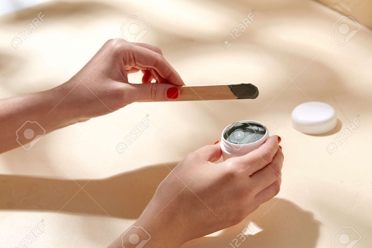 hands holding jar of blue cosmetic clay mask - 169965832 hands holding jar of blue cosmetic clay mask - 169965832