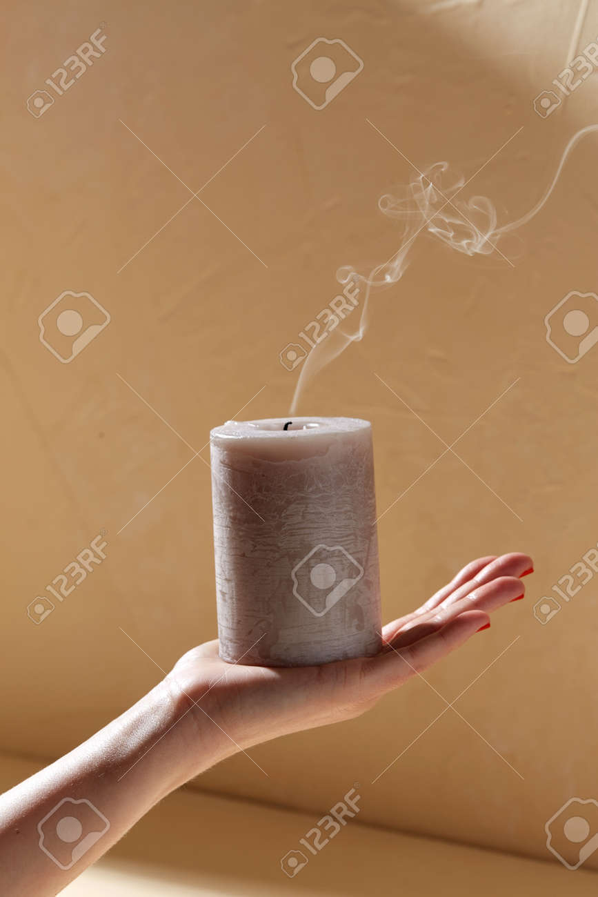 hand holding extinguished aroma candle on palm - 169967103 hand holding extinguished aroma candle on palm - 169967103