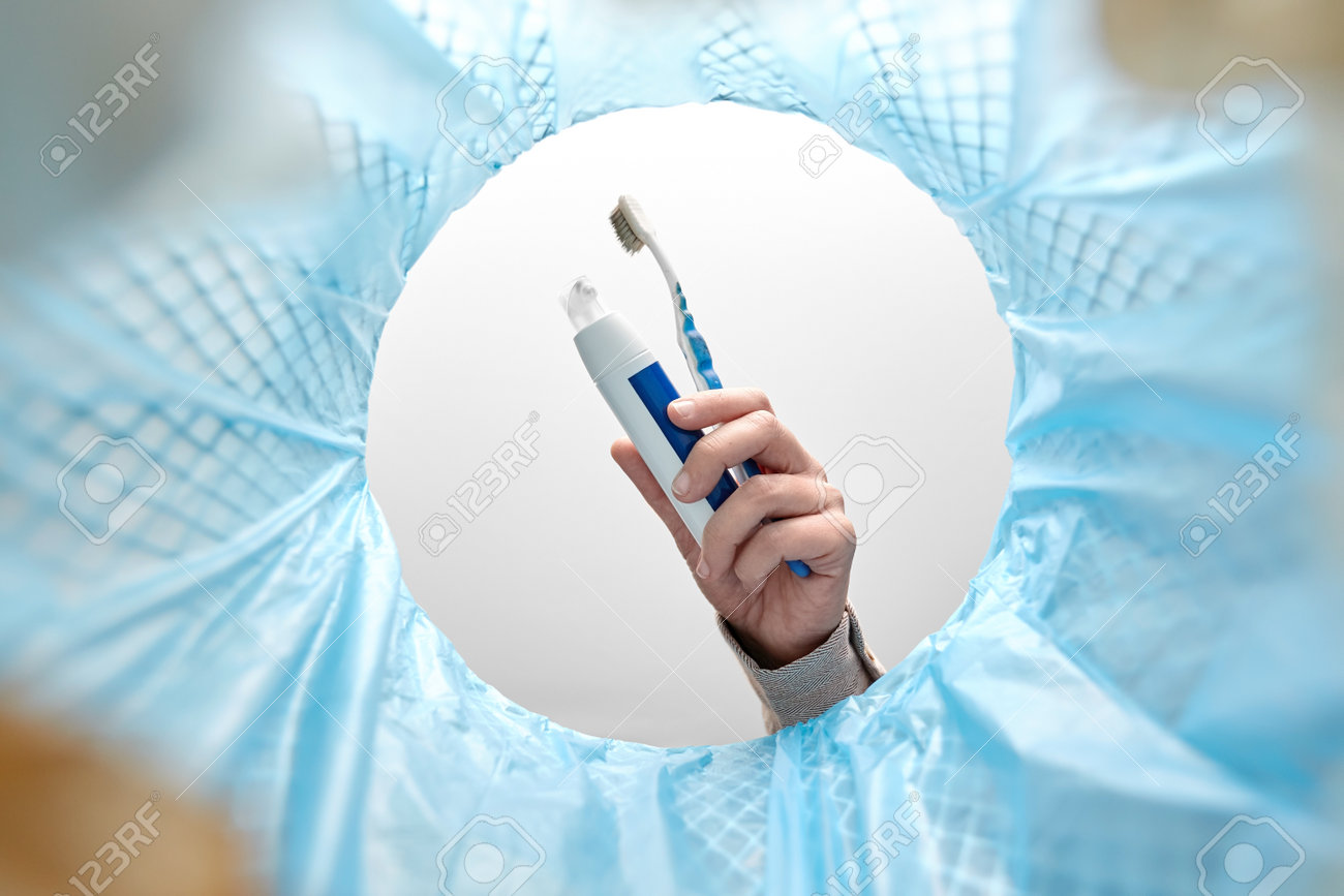 hand throwing toothbrush into trash can - 169966259 hand throwing toothbrush into trash can - 169966259