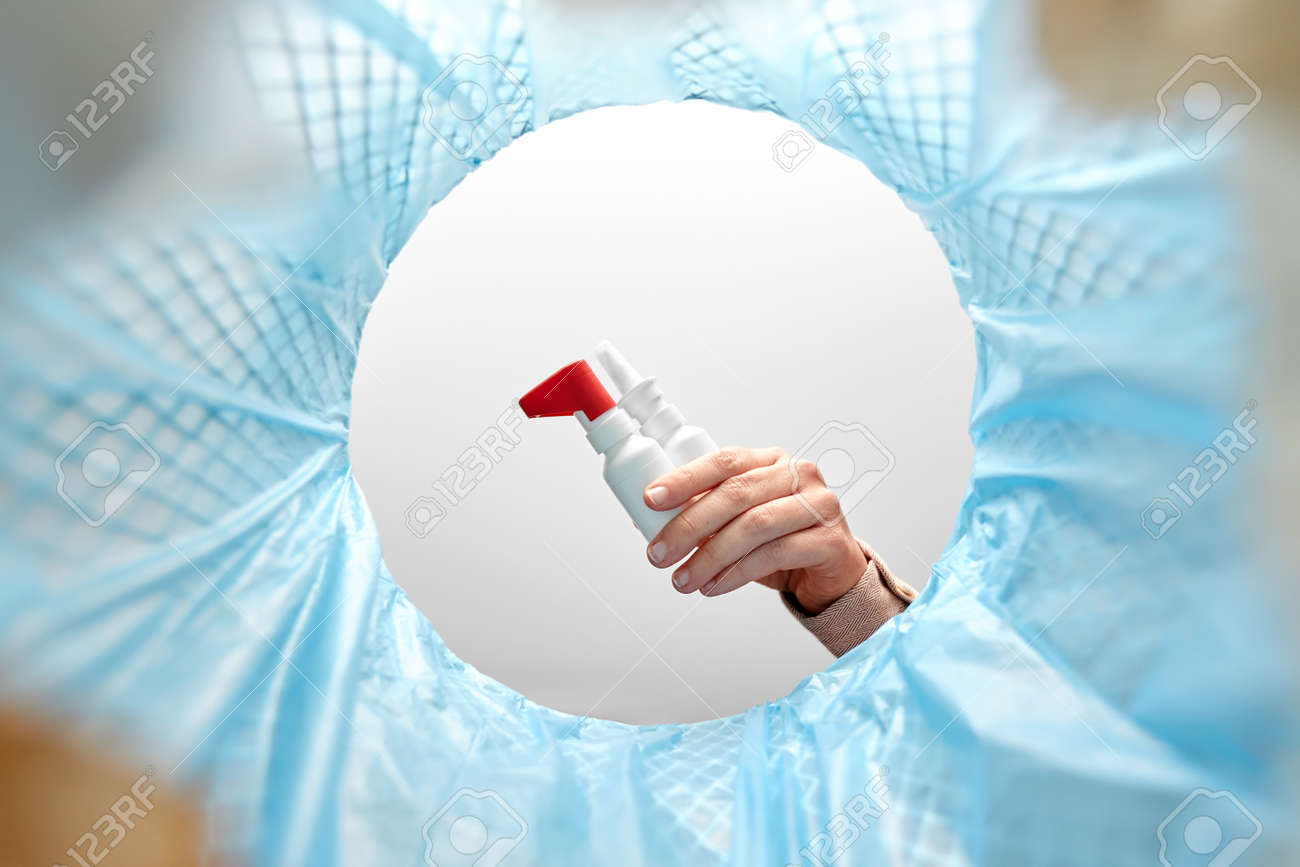 hand throwing old medicine into trash can - 169966862 hand throwing old medicine into trash can - 169966862