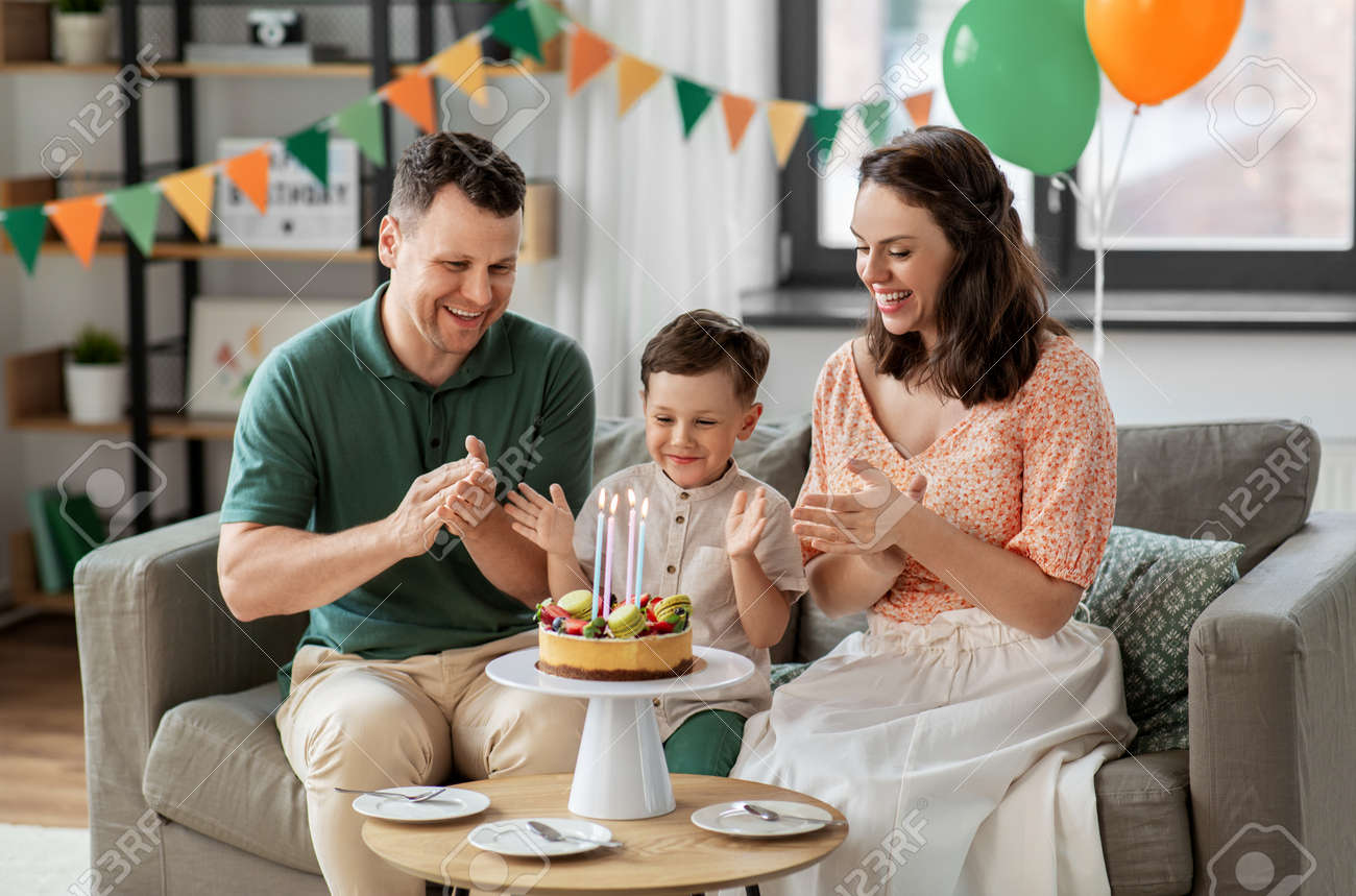 happy family with birthday cake at home - 169966360 happy family with birthday cake at home - 169966360