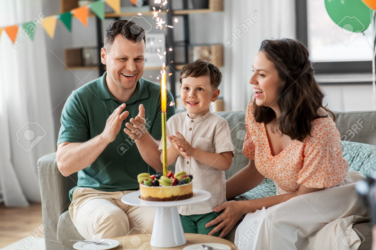 happy family with birthday cake at home - 169966406 happy family with birthday cake at home - 169966406