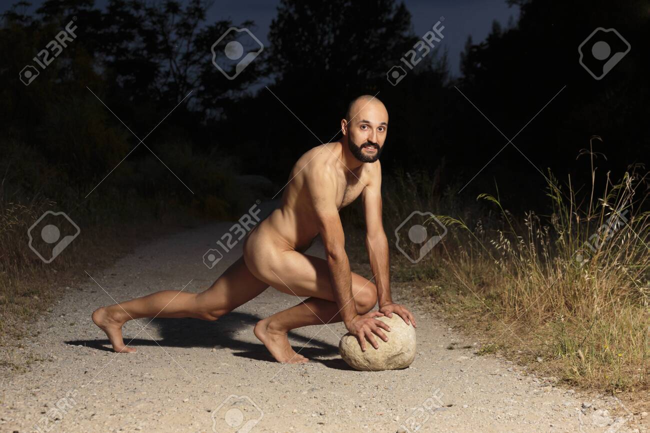 Young Male Athlete Fully Naked Crouching On A Trail At Night Looking At  Camera Stock Photo, Picture And Royalty Free Image. Image 153862351.