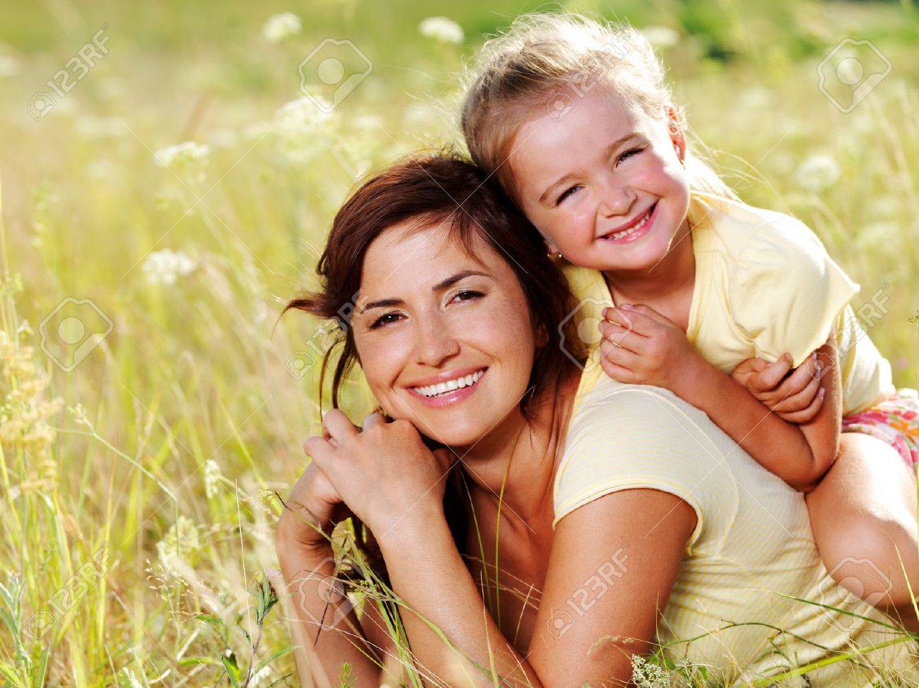 Smiling Mother And Little Daughter On Nature. Happy People Outdoors  Фотография, картинки, изображения и сток-фотография без роялти. Image  7506829.